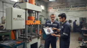 Engineers reviewing hydraulic minting machine blueprint in Ahmedabad workshop